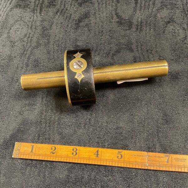Antique ebony and brass carpenters scribe for precise woodworking.