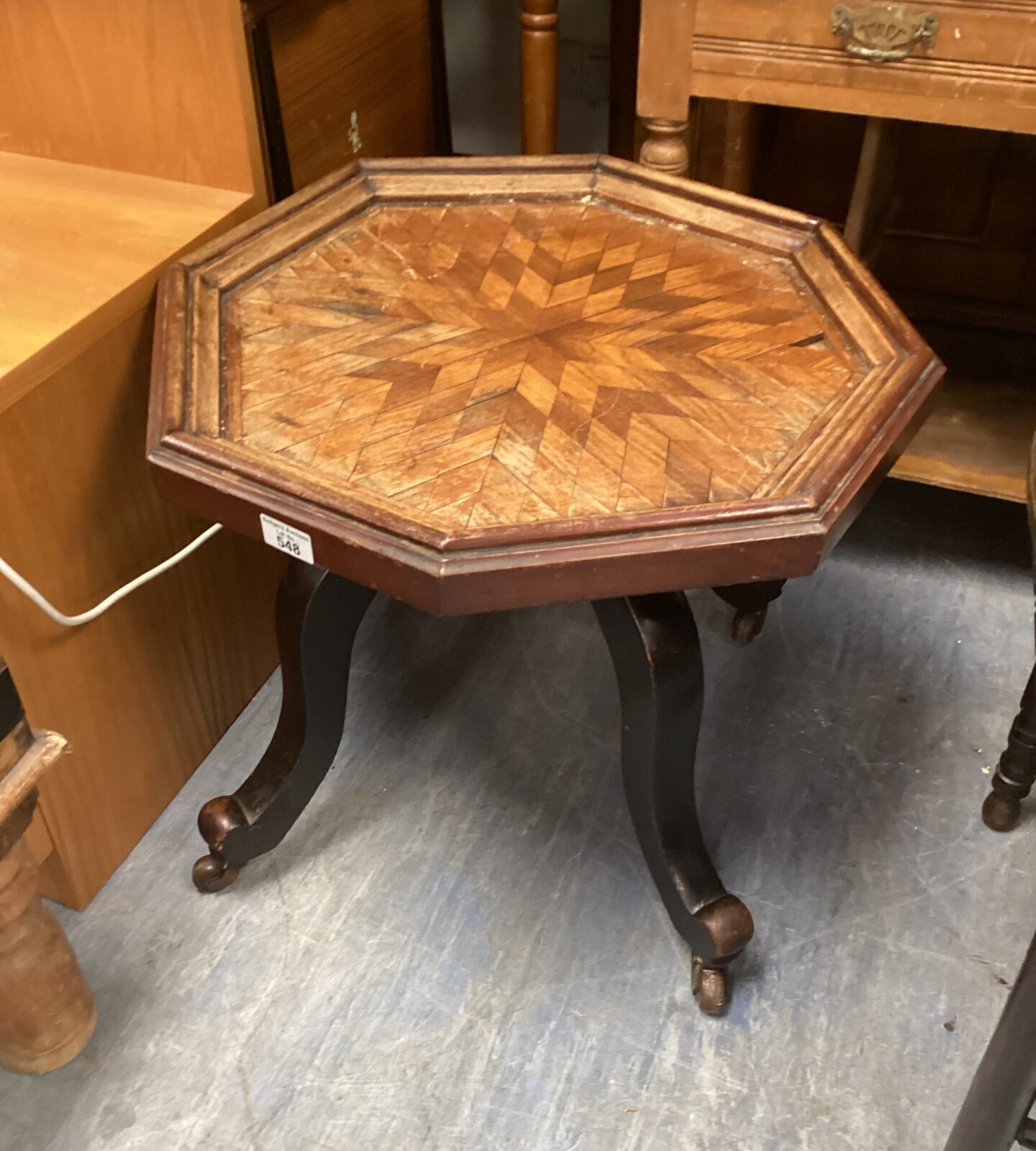 Antique hexagonal marquetry table with floral inlay and cabriole legs.