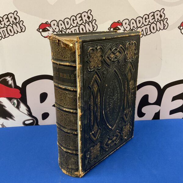 Antique 1869 Holy Bible with embossed cover and gilt edges.