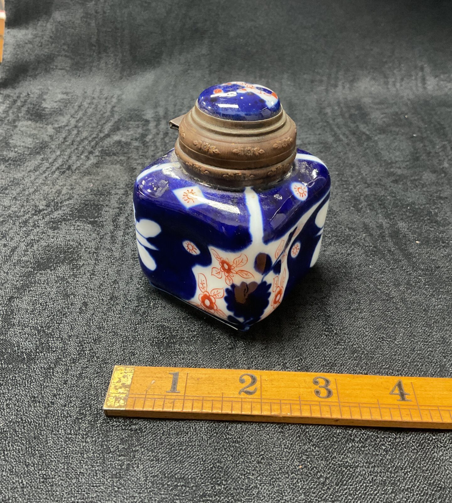 Antique 19th-century Imari inkwell with hinged bronze lid.