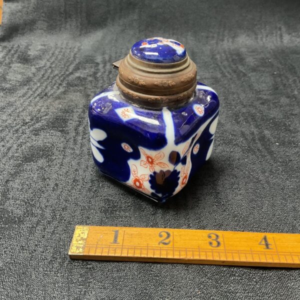 Antique 19th-century Imari inkwell with hinged bronze lid.