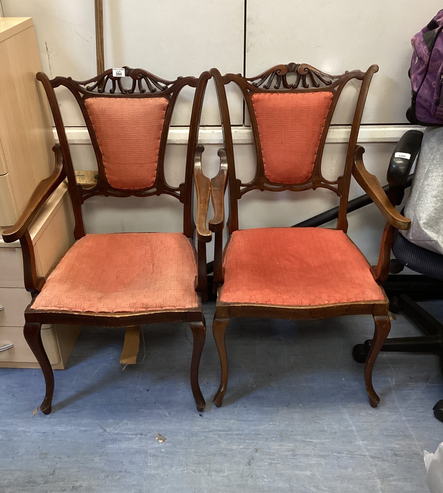 Pair of antique mahogany carver chairs with red upholstery.