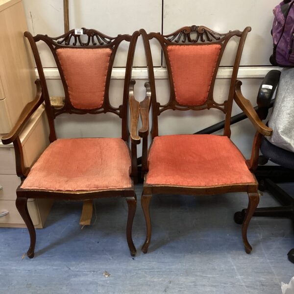 Pair of antique mahogany carver chairs with red upholstery.