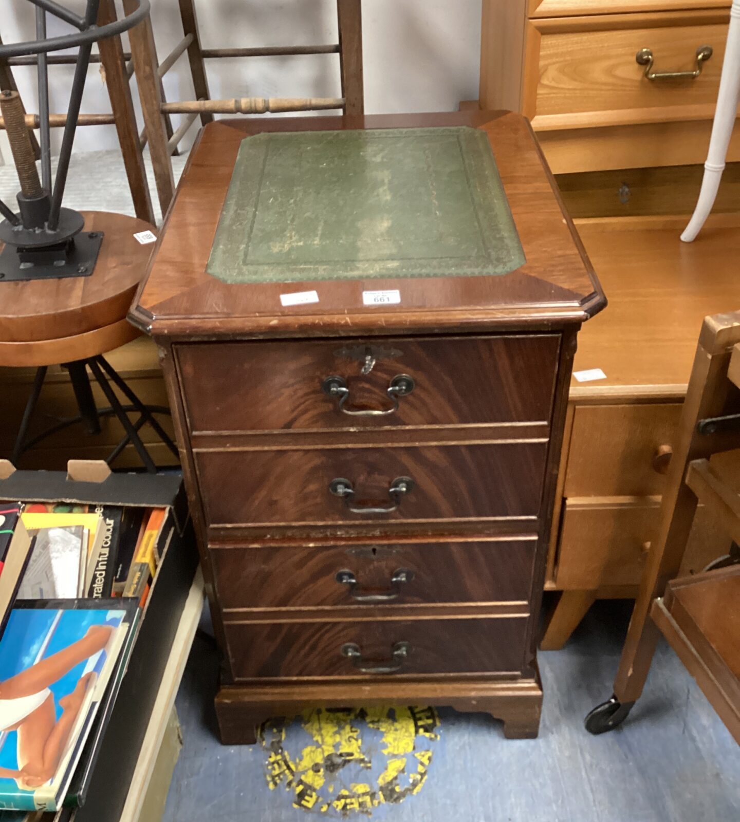 Antique mahogany filing cabinet with leather top for office storage.