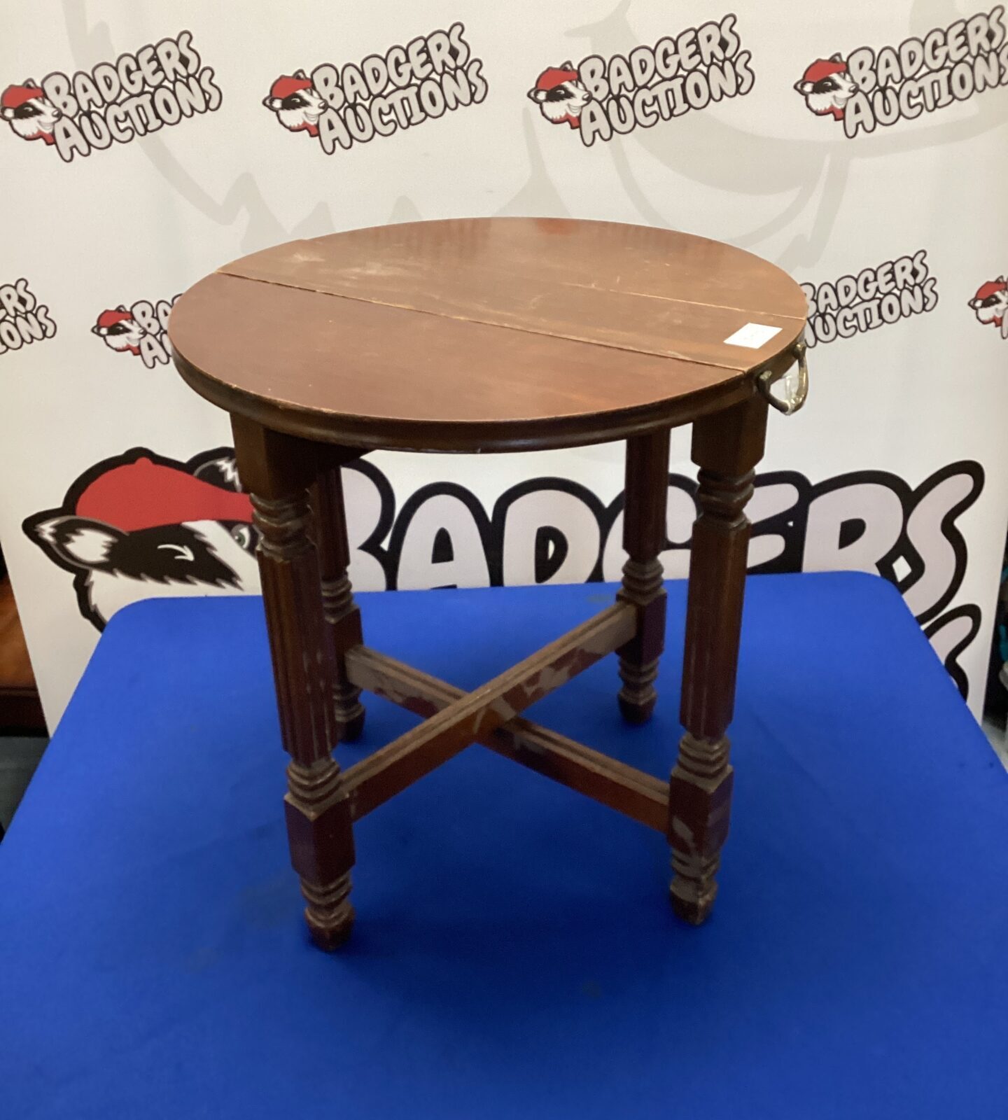 Antique mahogany folding side table with carved legs.
