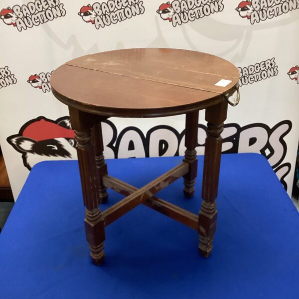 Antique mahogany folding side table with carved legs.