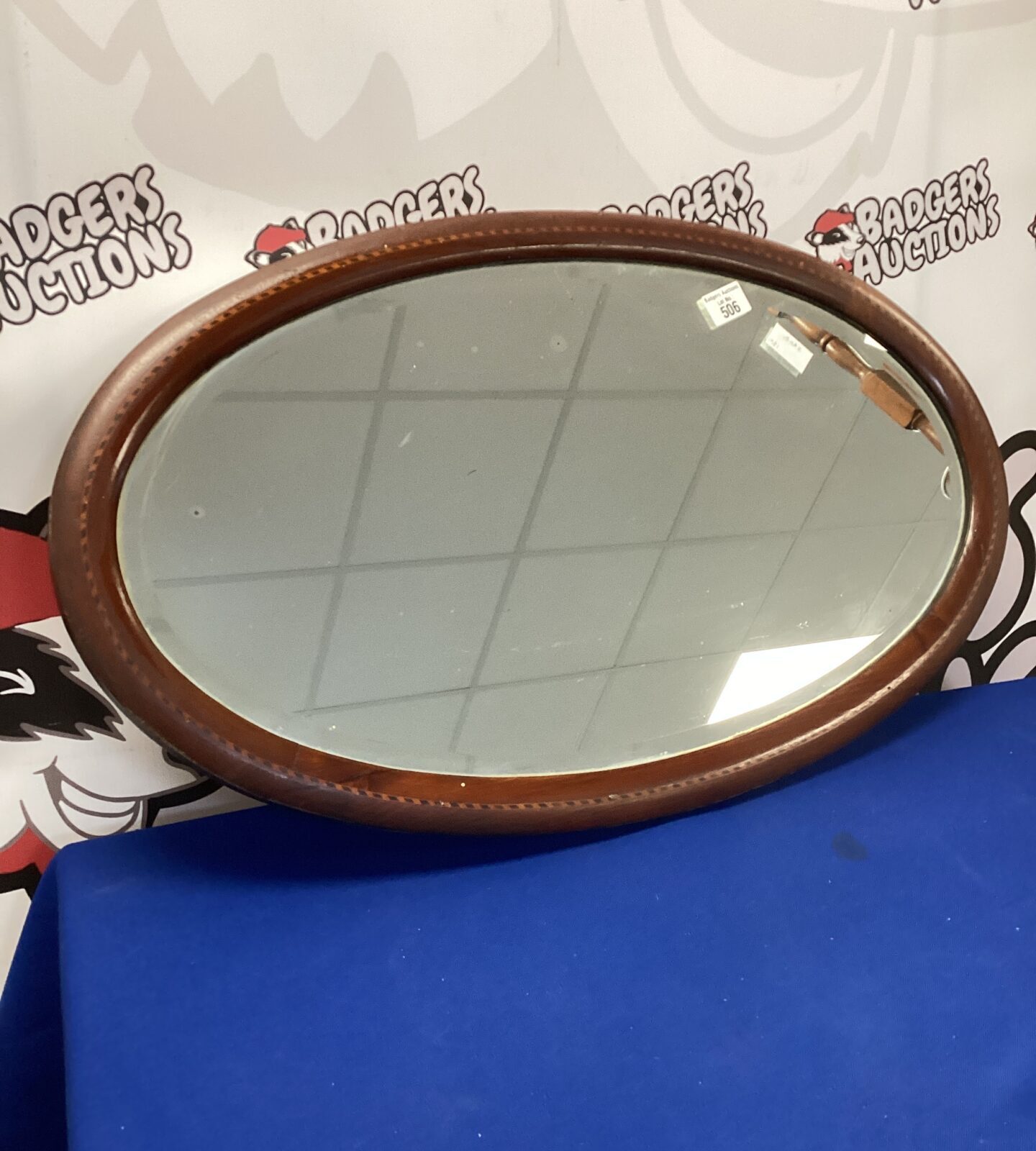 Antique mahogany inlaid oval mirror for wall decoration.