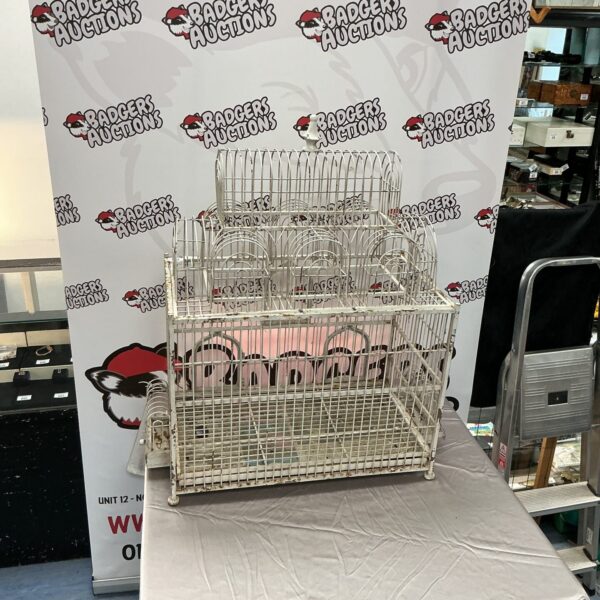 Antique metal bird cage with intricate wirework, vintage decorative piece.
