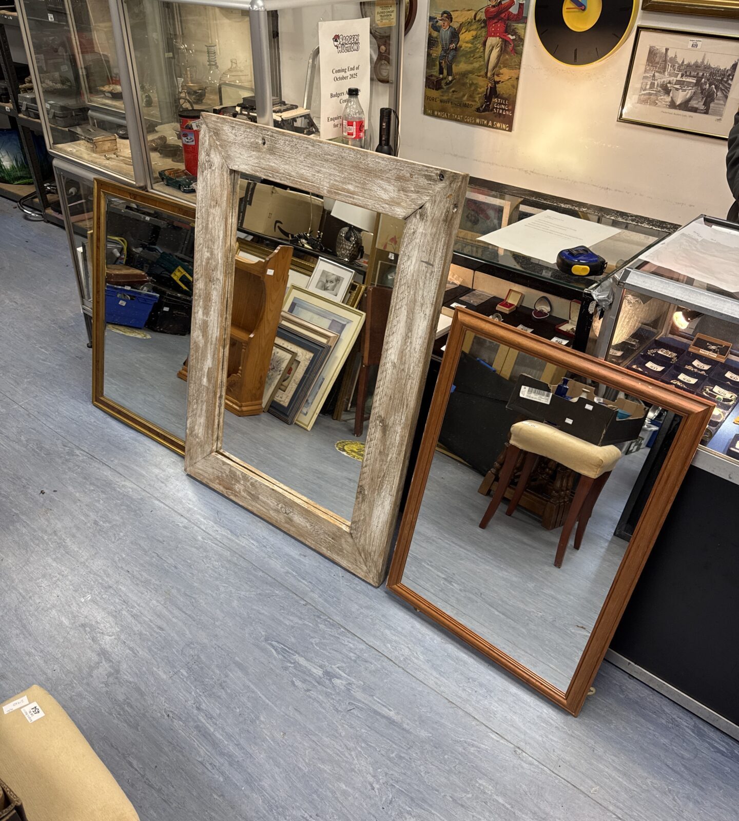 Large antique mirror with bevelled glass and ornate frame.