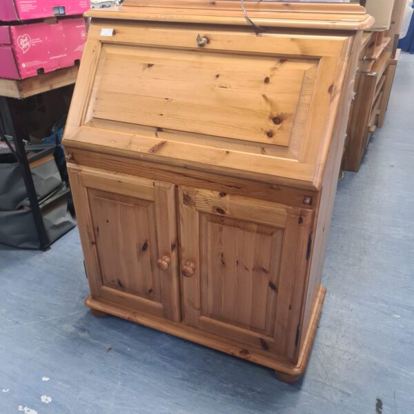 Front view of antique pine writing bureau with drawers.
