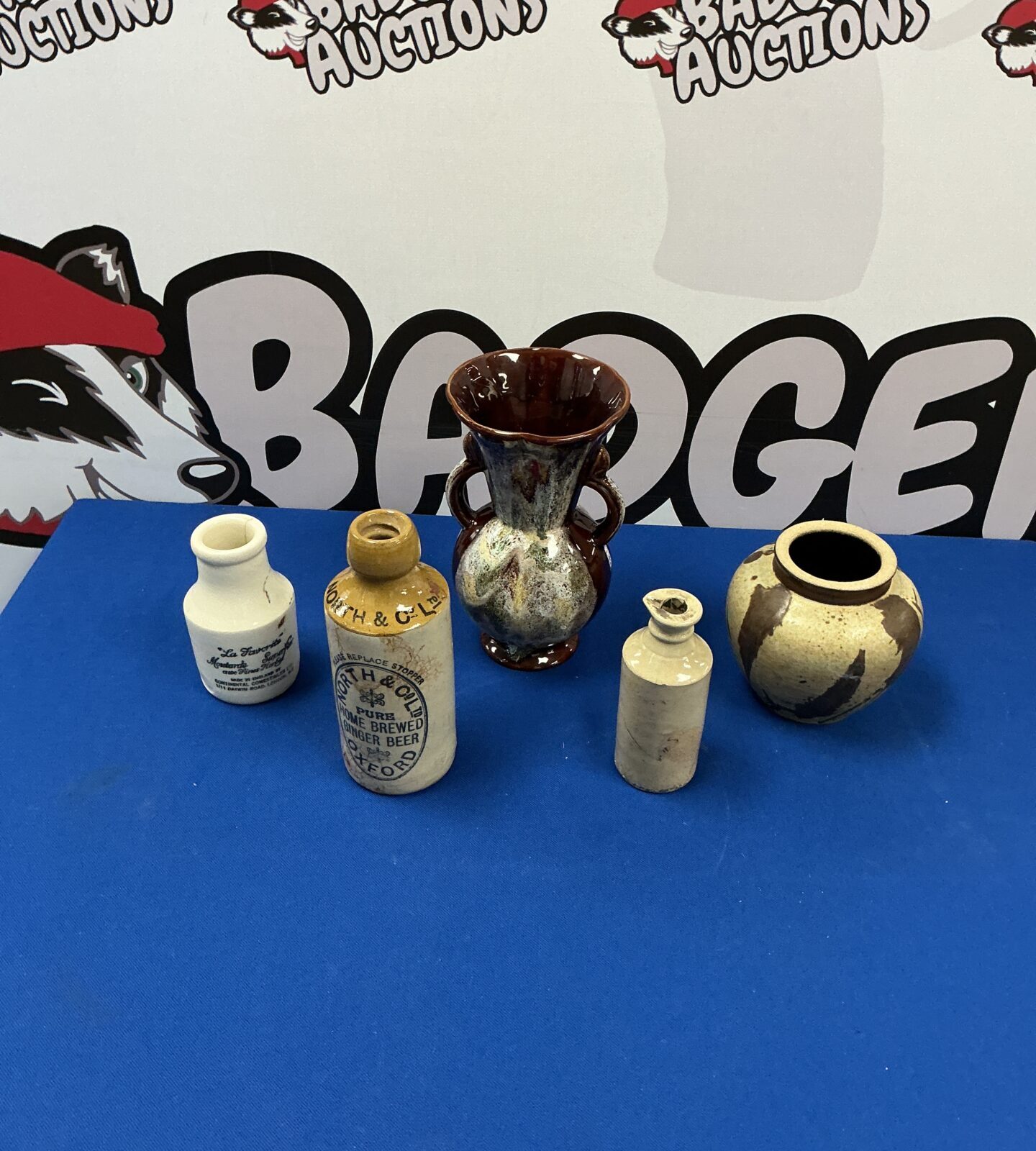 Antique pottery collection featuring a glazed vase and smaller vessels.
