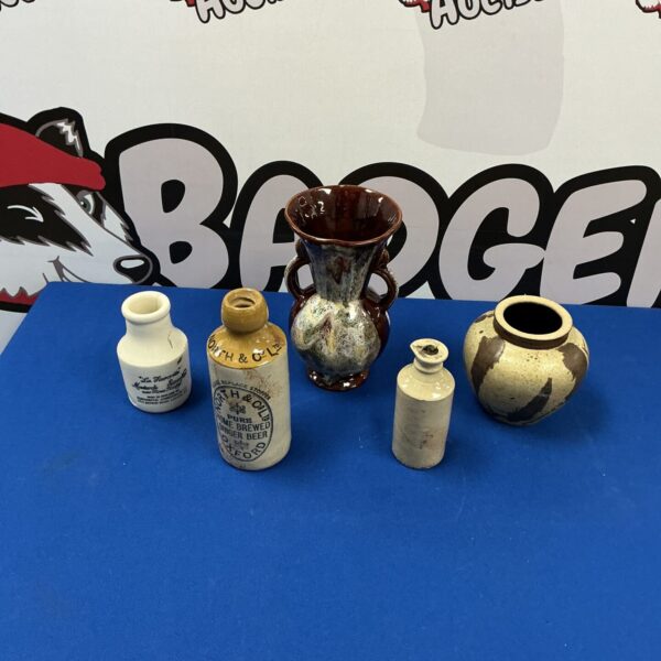 Antique pottery collection featuring a glazed vase and smaller vessels.