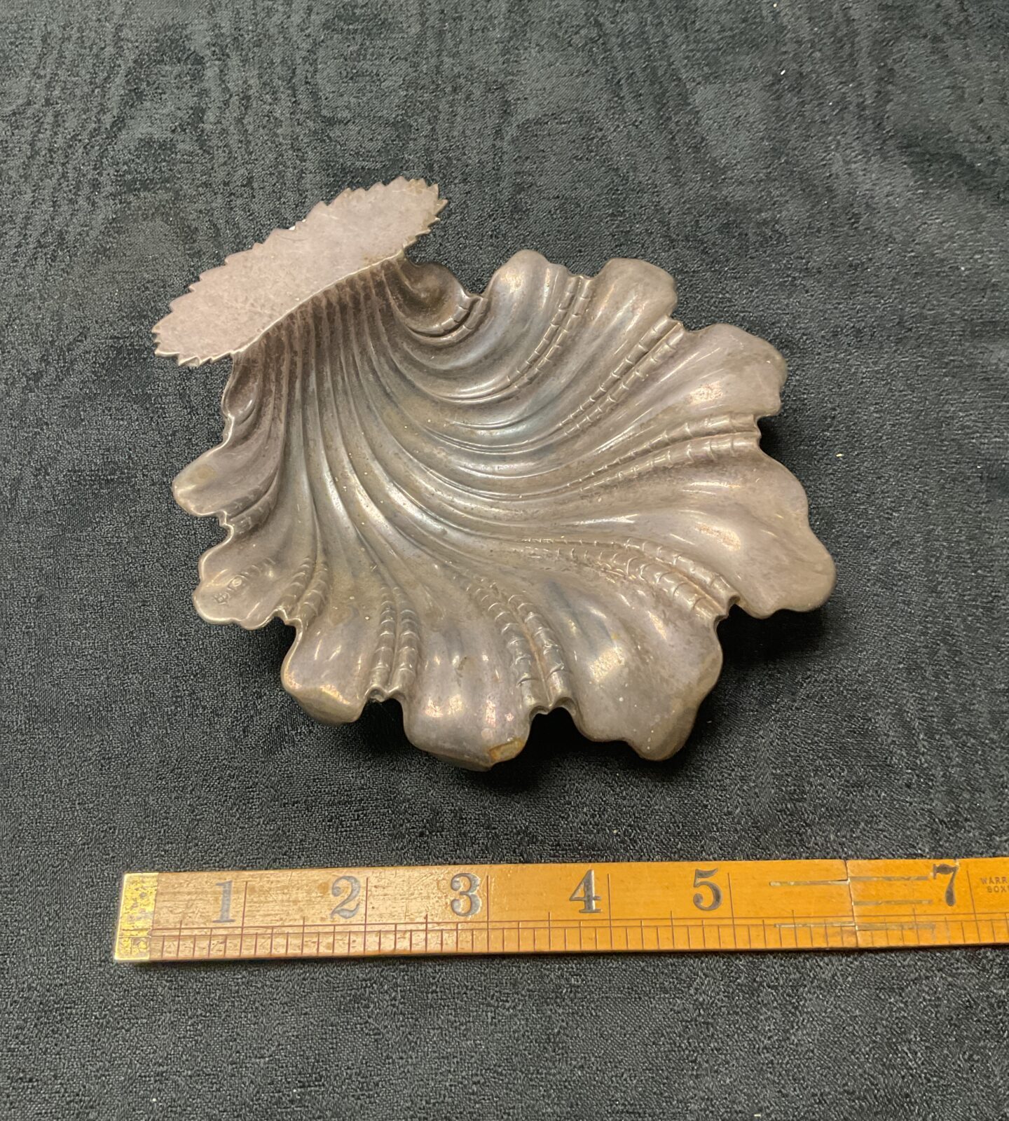 Antique silver leaf dish with intricate detailing.