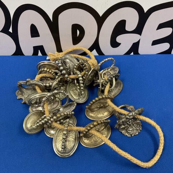 Antique silver plated tureen handles with decorative embossed designs.