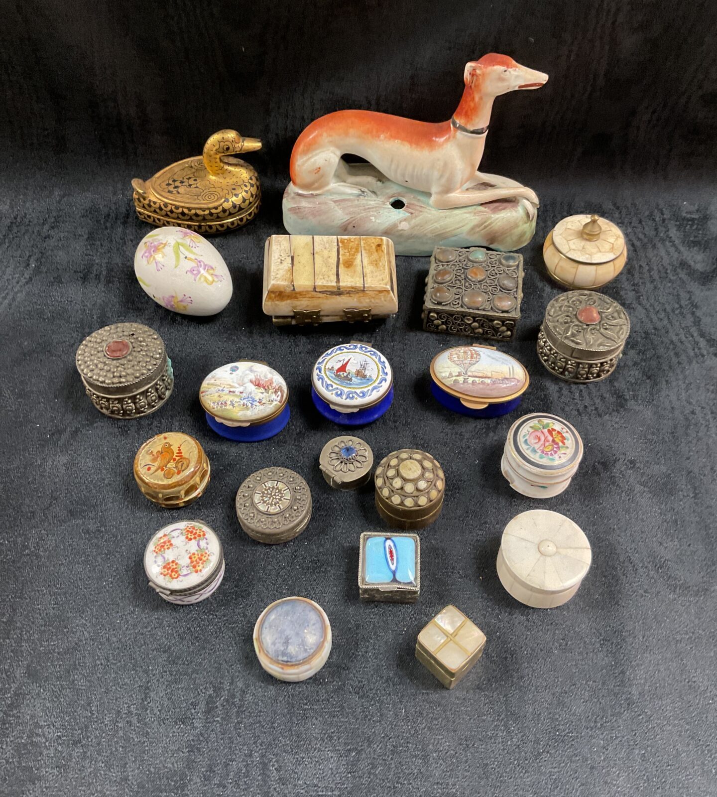 Antique trinket pot collection featuring enamel and metal boxes.