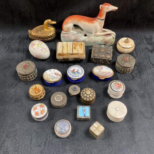 Antique trinket pot collection featuring enamel and metal boxes.
