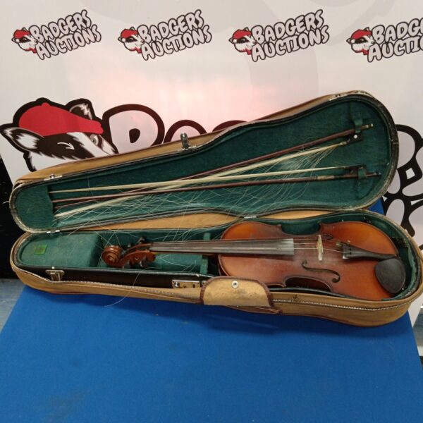 Antique violin in open case with bows, vintage musical instrument.