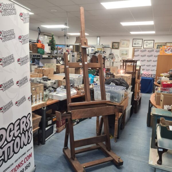 Large antique wooden artist easel on casters, ideal for studio use.