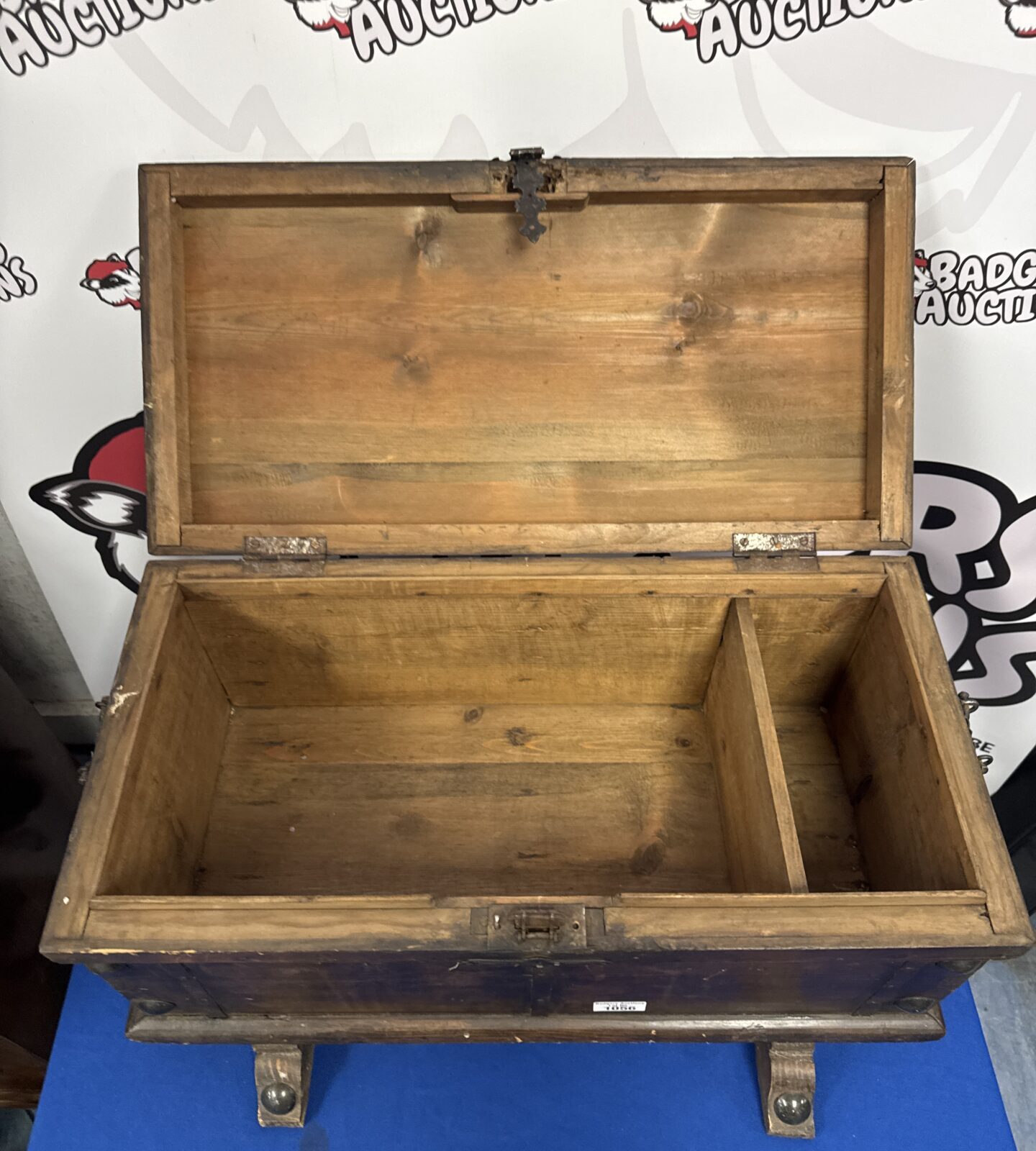 Side view of antique wooden storage box with measuring tape.