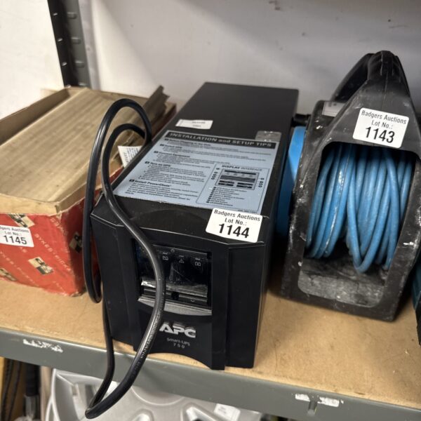 Black APC Smart UPS 750 power supply unit with cables.