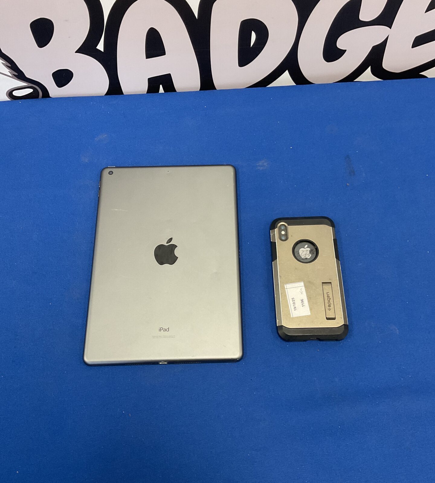 Silver Apple iPad A2197 tablet on a blue background.