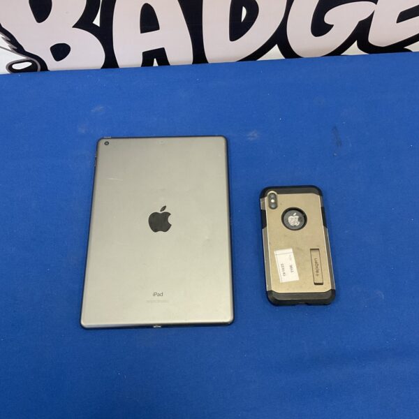 Silver Apple iPad A2197 tablet on a blue background.