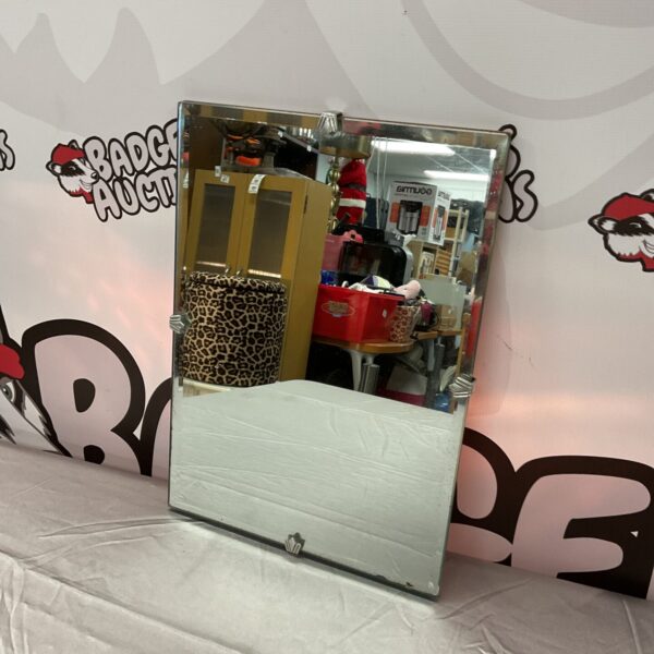 Vintage 1930s Art Deco mirror with geometric design.
