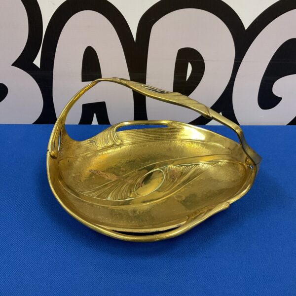 Vintage Art Nouveau brass dish with a delicate handle.