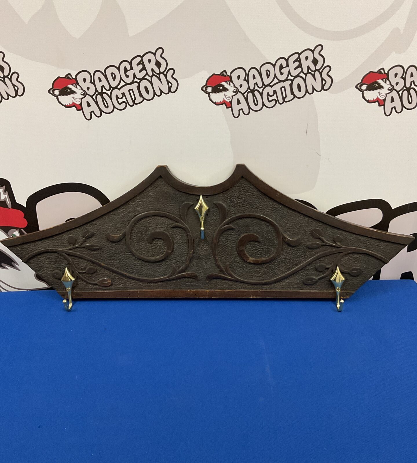 Vintage Art Nouveau coat rack with intricate carved wood details.