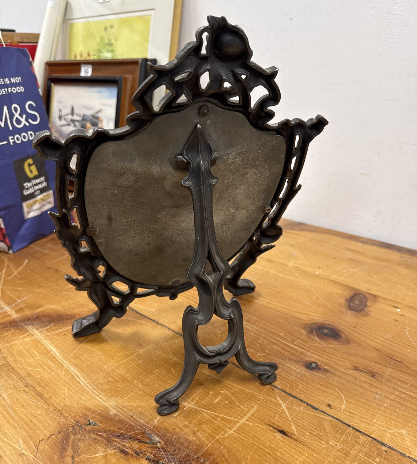 Side view of antique Art Nouveau Scottish pewter easel mirror.