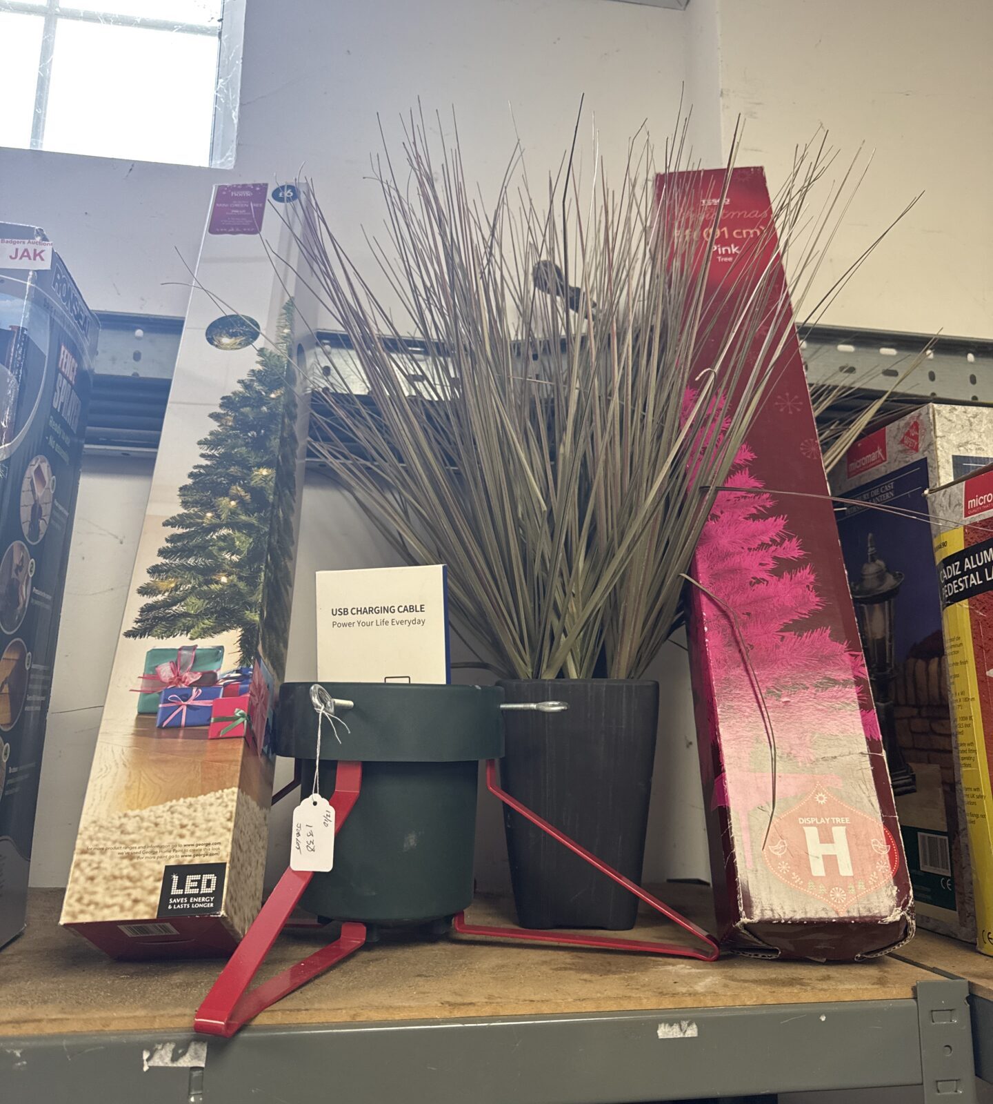 Bundle of artificial Christmas trees and festive decorations.