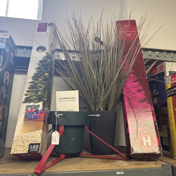 Bundle of artificial Christmas trees and festive decorations.