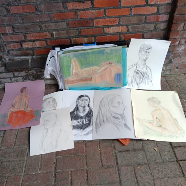Artist portfolio with nude and portrait sketches in pencil and pastel.