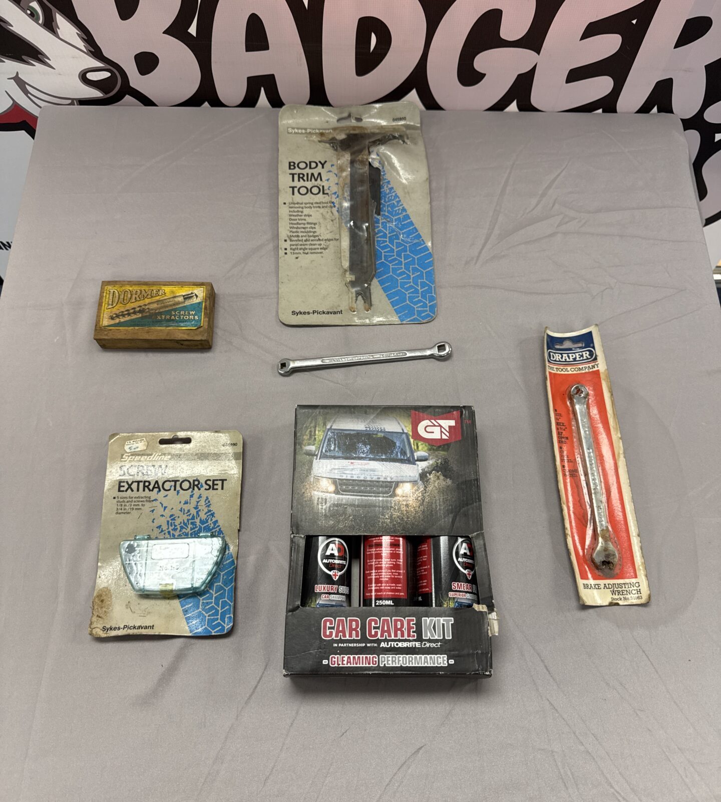 Automotive care kit with body trim tool and screw extractors.