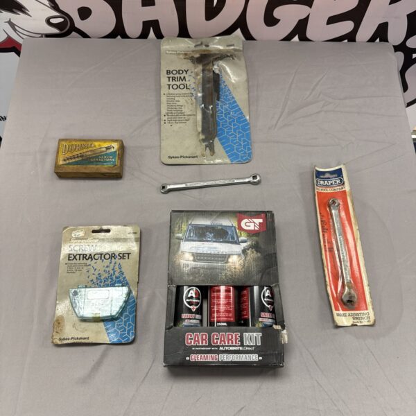 Automotive care kit with body trim tool and screw extractors.