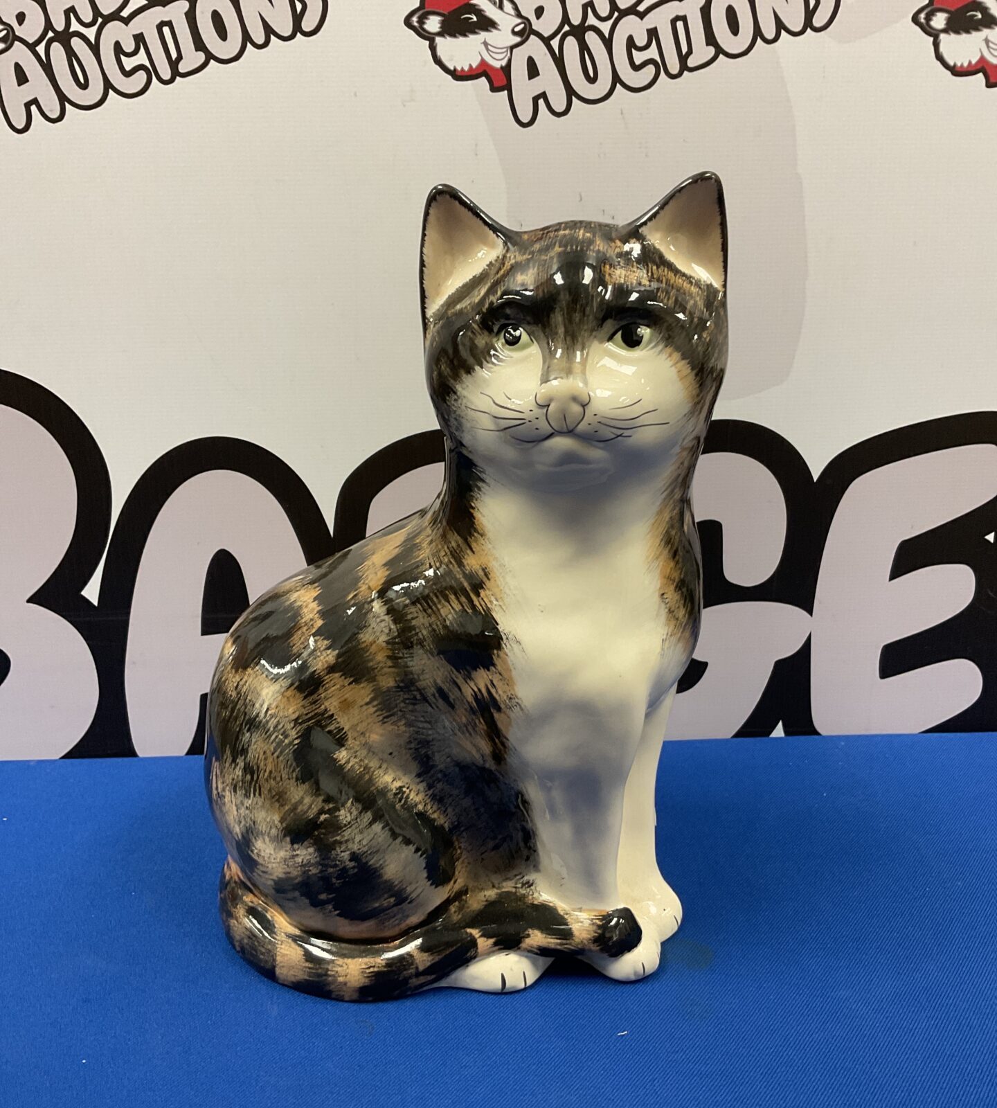 Large vintage Babbacombe Devon tortoiseshell cat figurine on display.