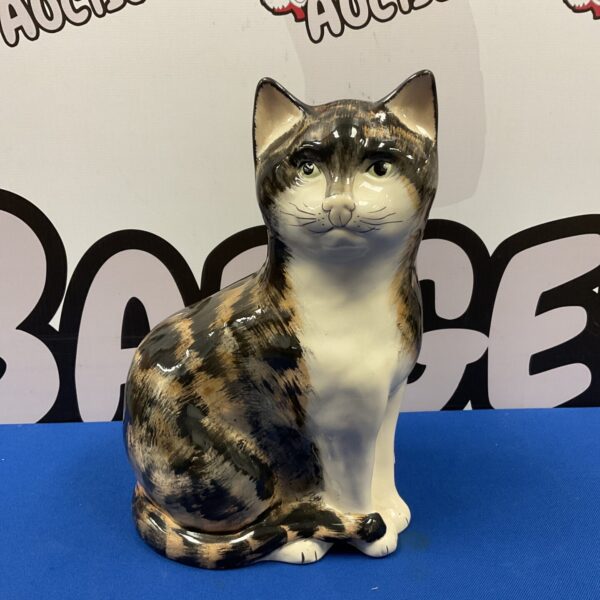 Large vintage Babbacombe Devon tortoiseshell cat figurine on display.