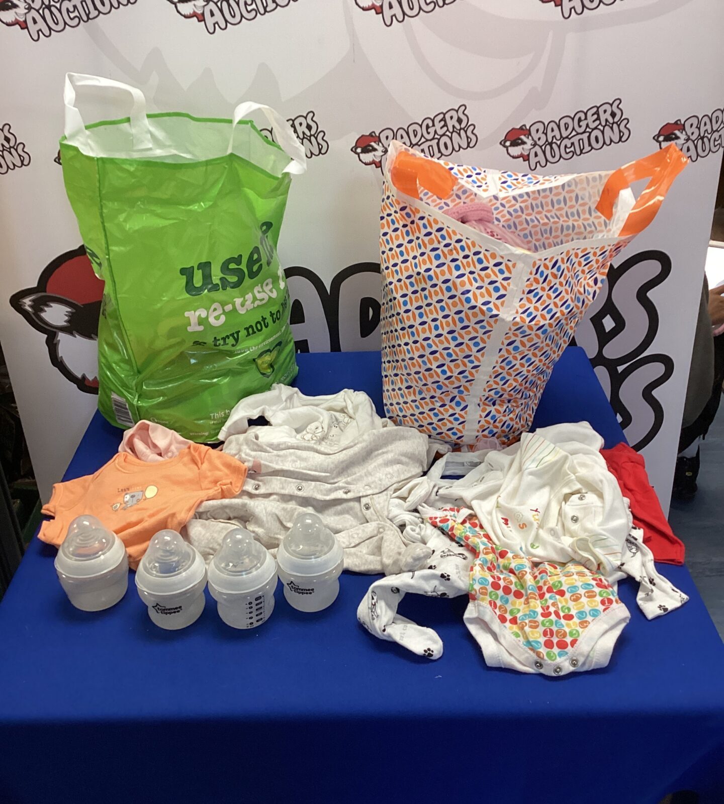 Mixed baby clothes and Tommee Tippee bottles in a bundle.