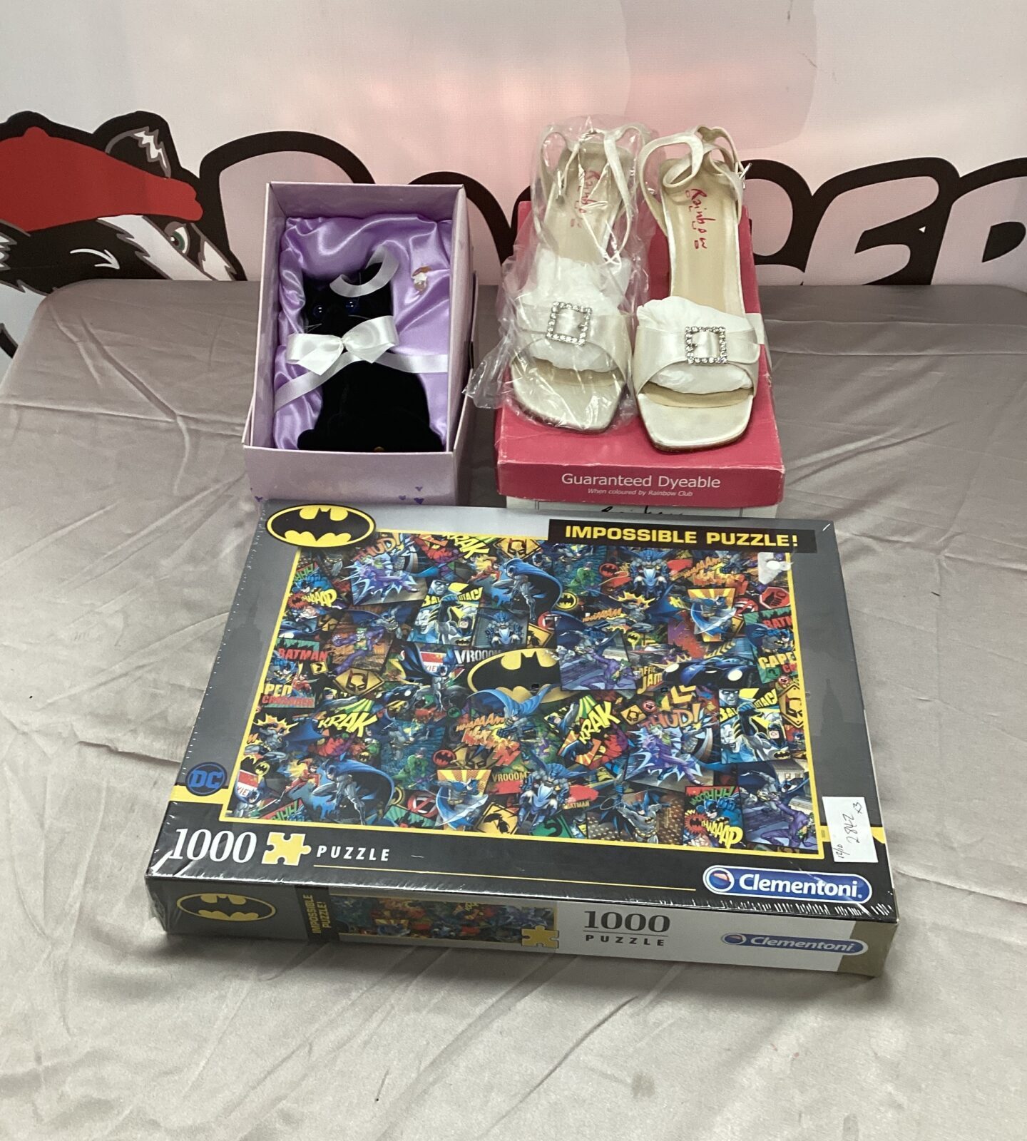 New Batman puzzle with rainbow shoes and black cat figurine.