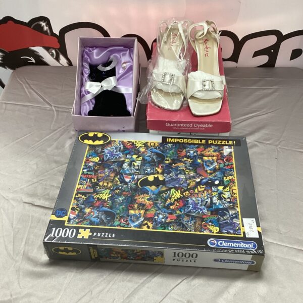 New Batman puzzle with rainbow shoes and black cat figurine.