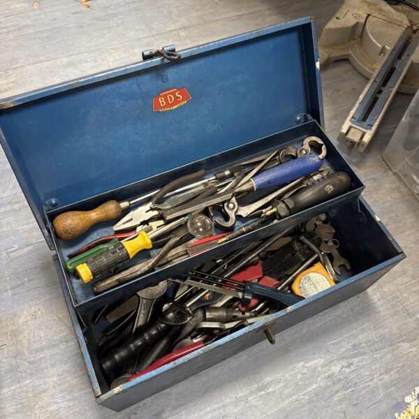 Vintage BDS metal toolbox filled with various hand tools.