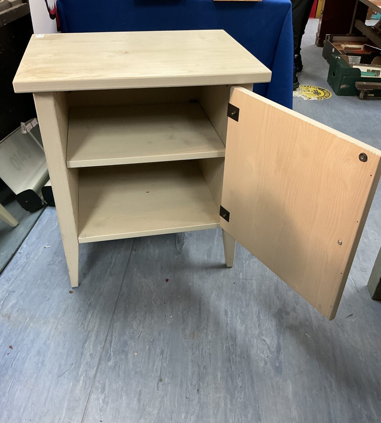 Side view of a vintage wooden bedside cabinet.