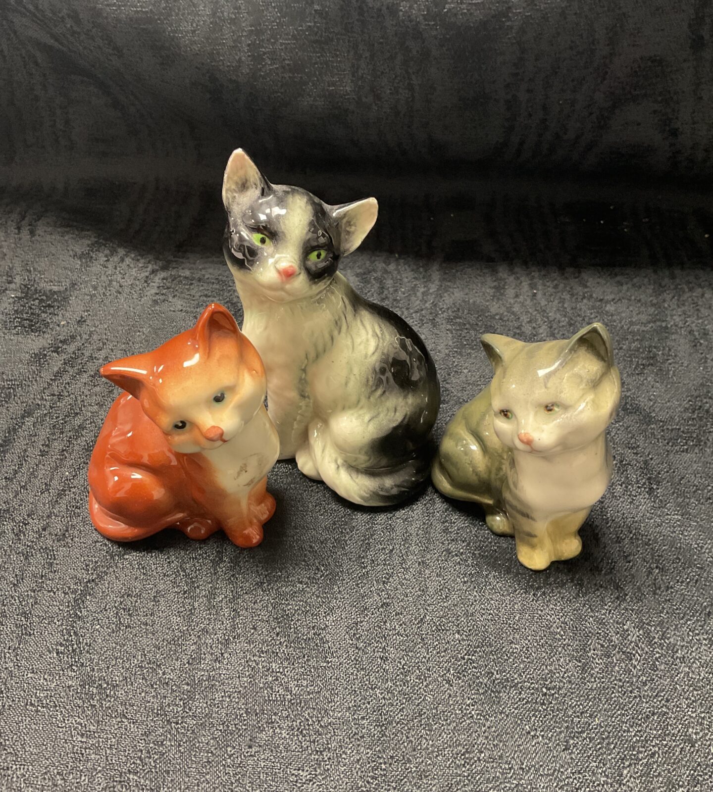 Vintage Beswick and Goebel ceramic cat figurines on display.