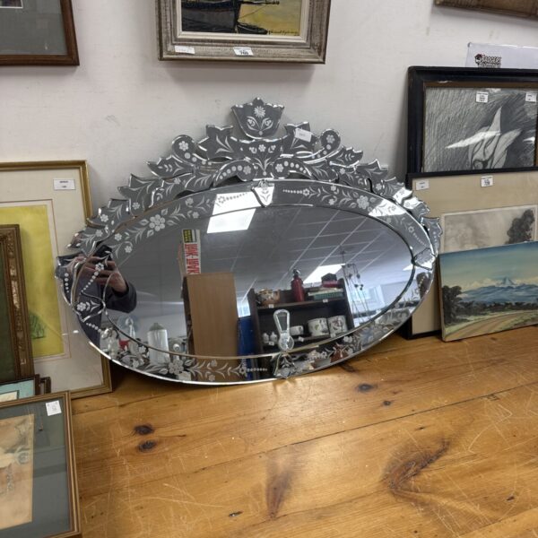 Ornate vintage bevel edge mirror with floral detailing.