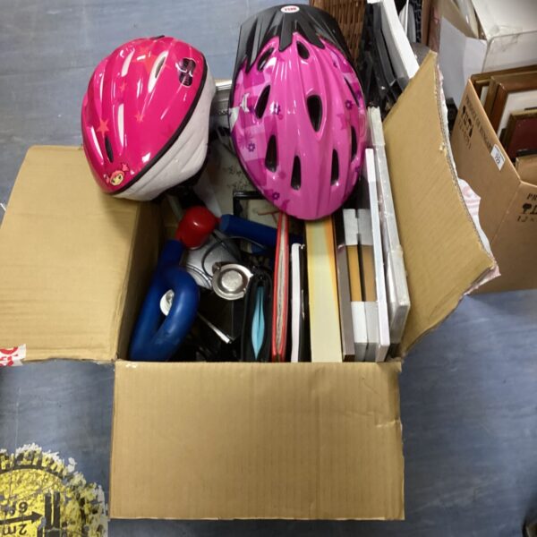 Mixed lot of colourful bike helmets for cycling safety.