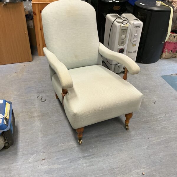 Cream upholstered vintage Billow and Co armchair with wooden legs.