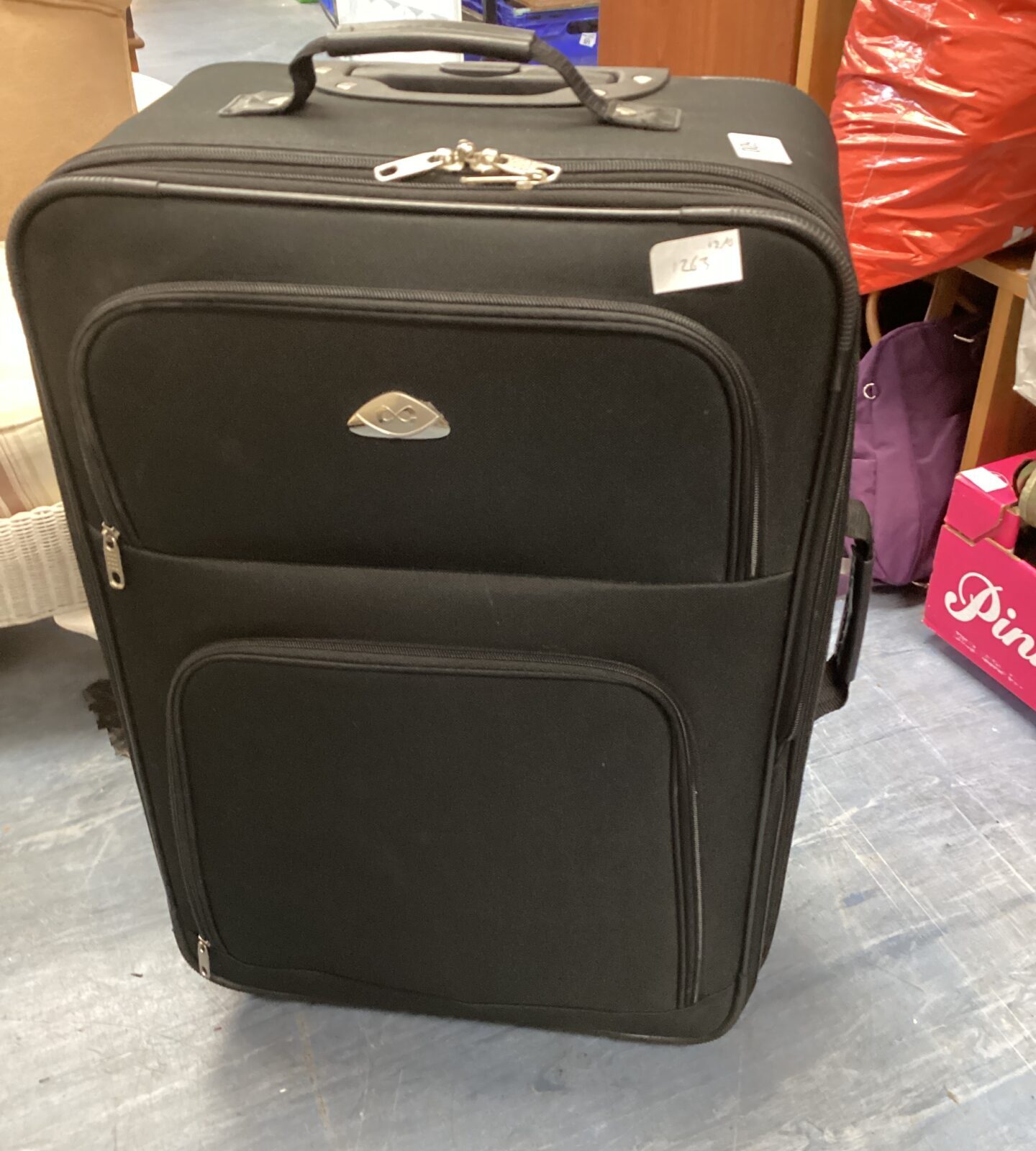 Black wheeled suitcase with extendable handle for convenient travel.