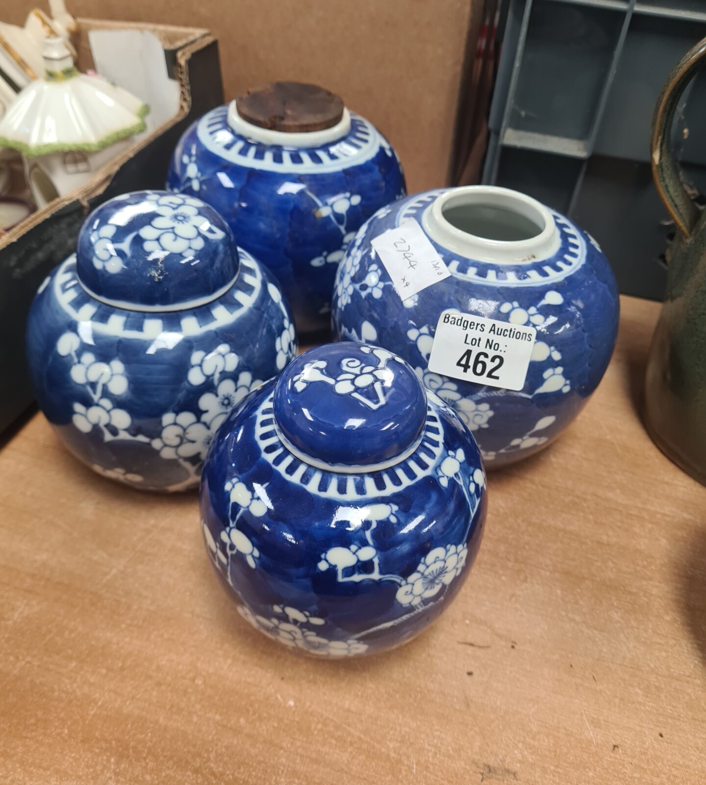 Set of four Chinese blue and white ginger jars on display.