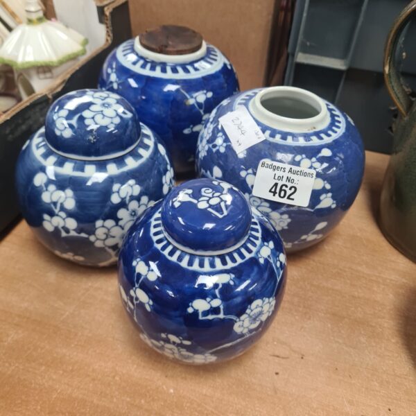 Set of four Chinese blue and white ginger jars on display.