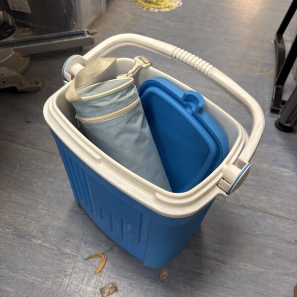 Bright blue cooler box with white bottle cooler inside.